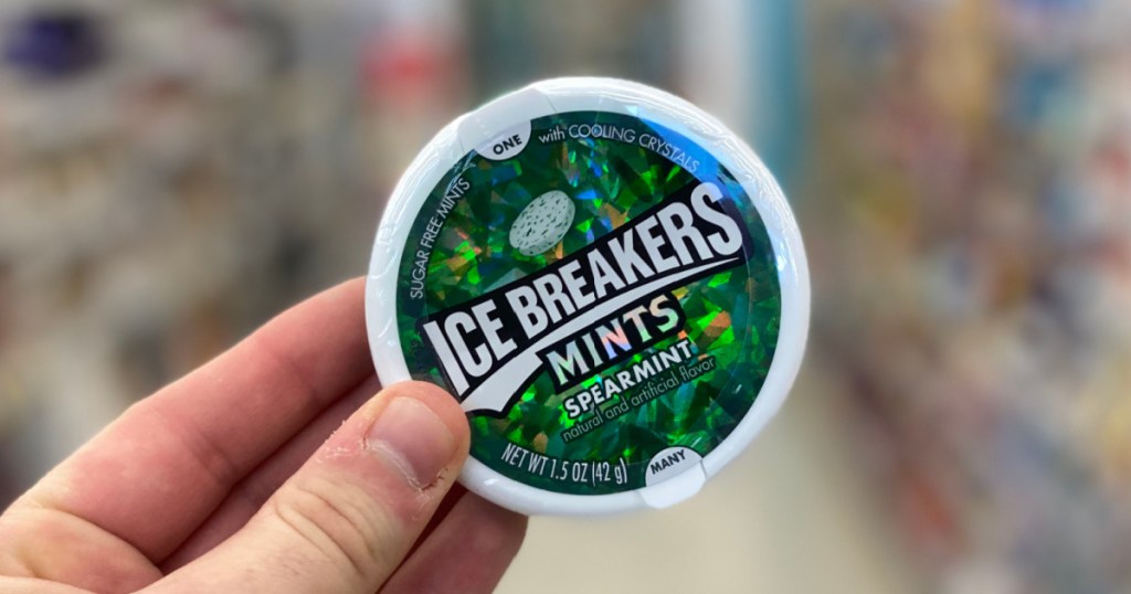 hand holding tin of mints 