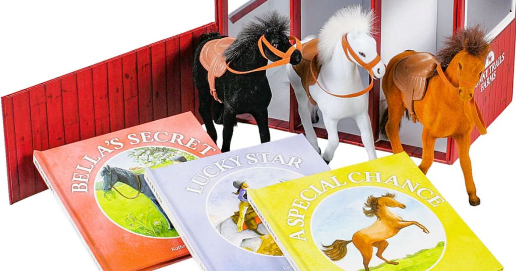 three toy horses next to books