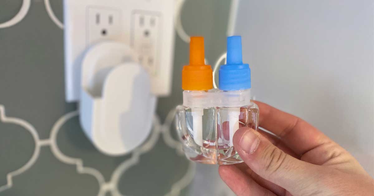 hand holding up a plug in air freshener