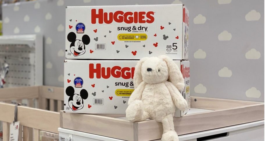 huggies snug & dry diapers stacked on top of a crib