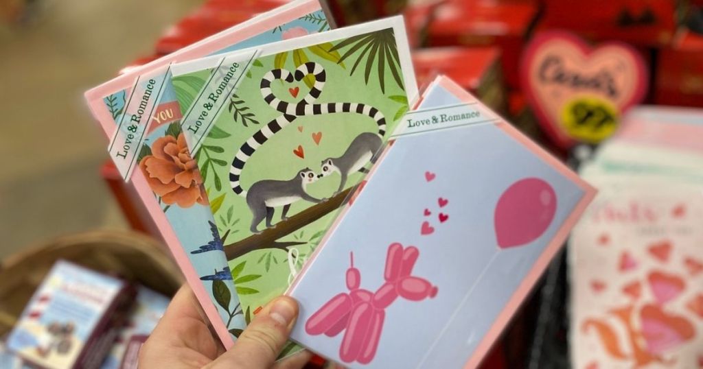 hand holding 3 Trader Joe's Valentines Greeting Cards