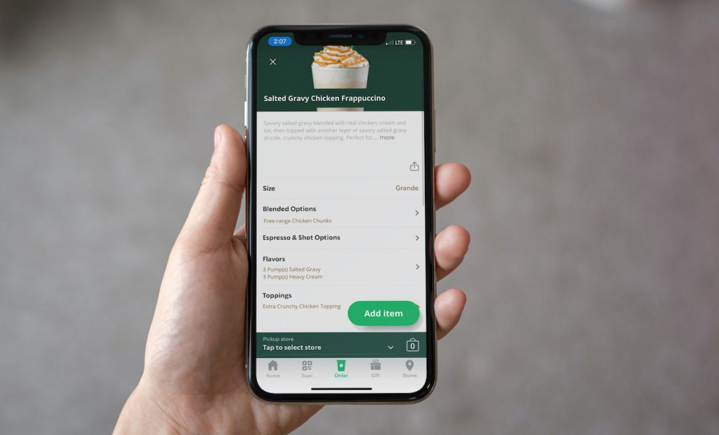 hand holding a phone with starbucks order on screen