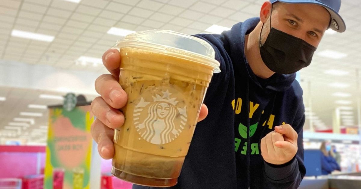 man holding a Starbucks coffee