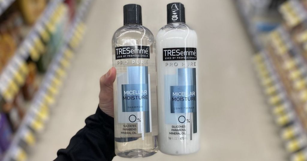 hand holding TRESemm&eacute; Shampoo and Conditioner in store