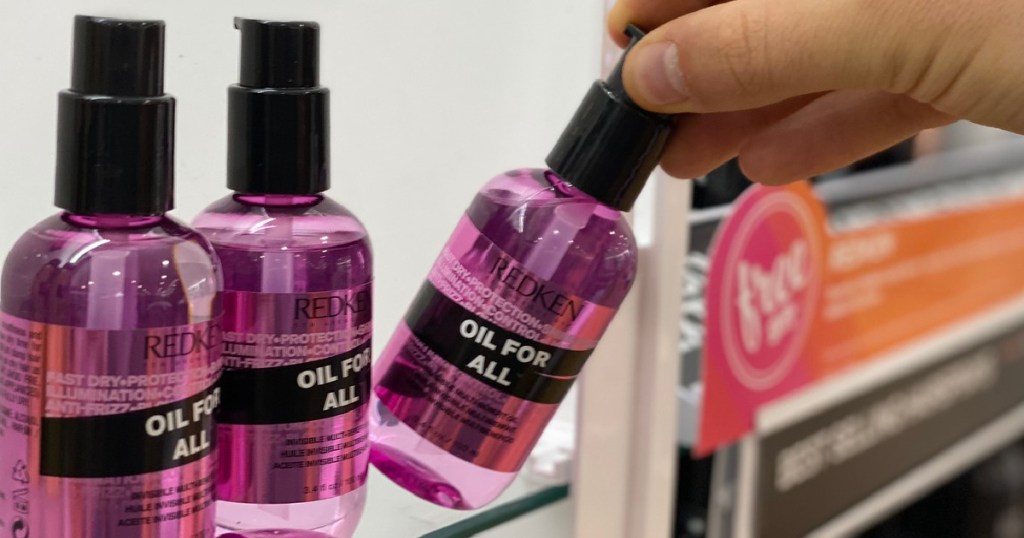 hand pulling Redken Spray off shelf