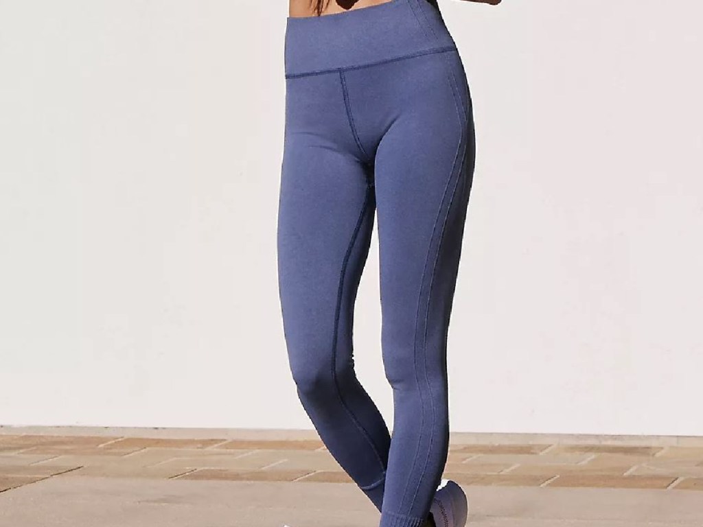 females legs with purple leggings on