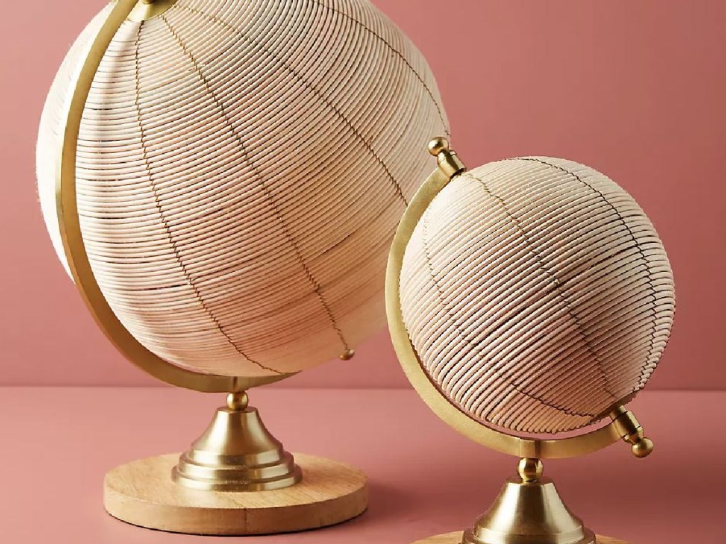 2 globes in gold coloring and made from rattan