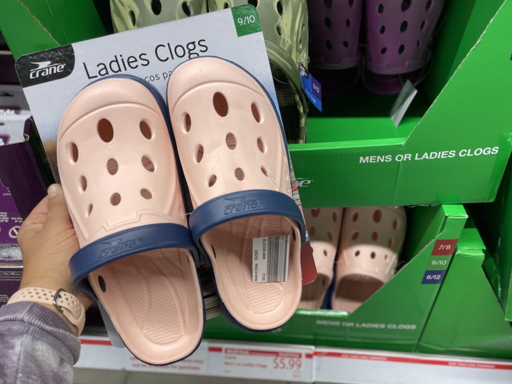 women's pink clogs in packaging near in-store display
