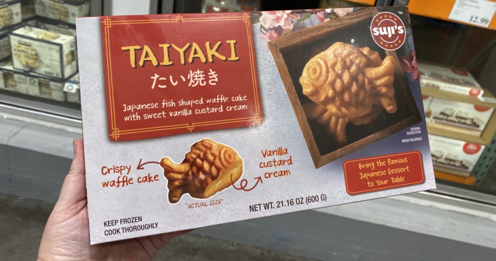hand holding a box of Suji&rsquo;s Taiyaki Fish Waffles 