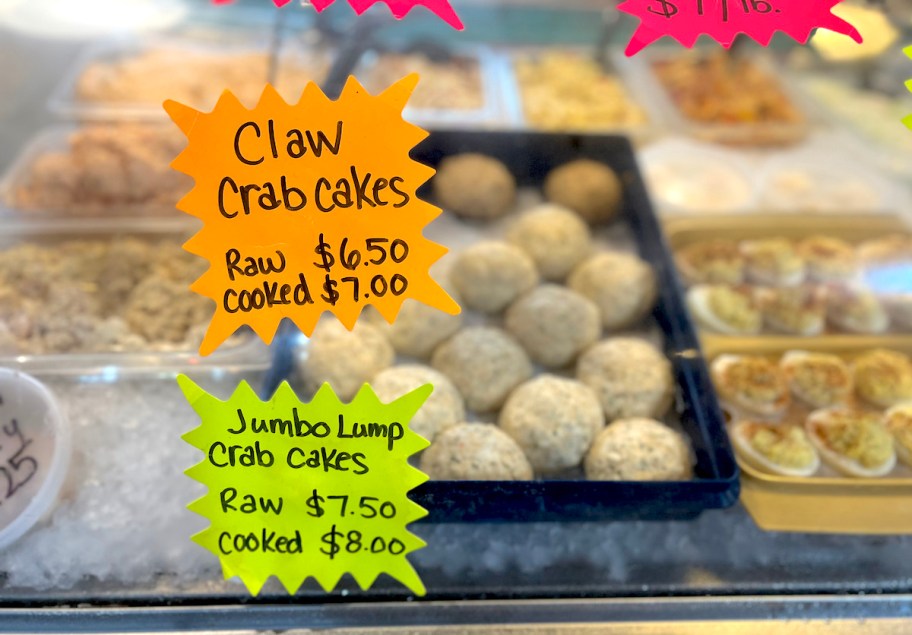 crab cakes in cooler with neon paper signs
