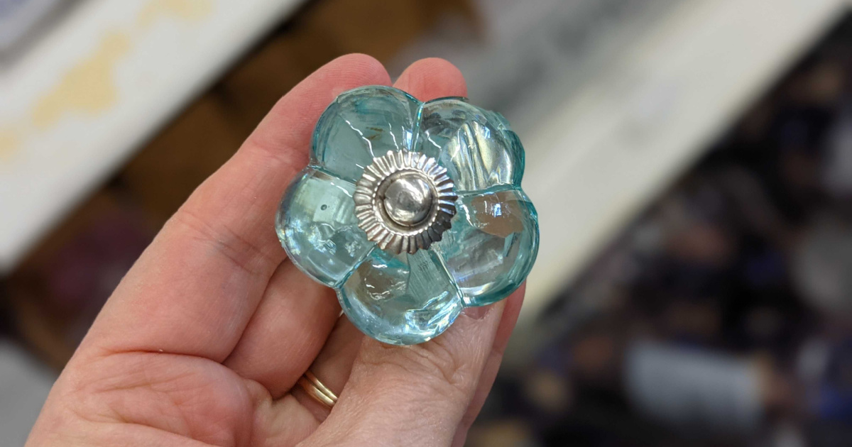 Hand holding glass doorknobs