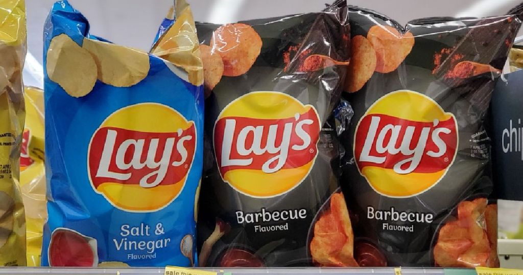 blue and black bags of chips on display in store
