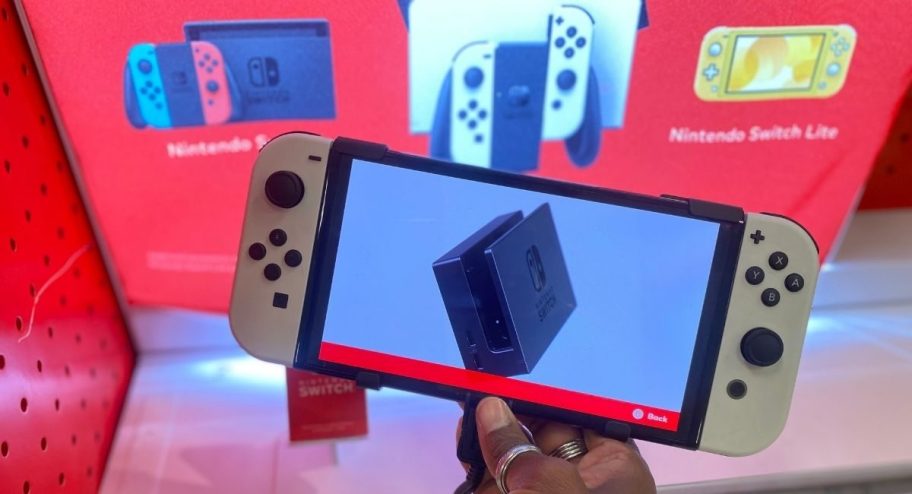 hand holding a white Nintendo Swtich in store