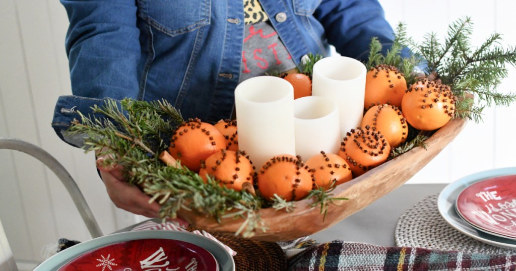 holding a bowl with pomander balls