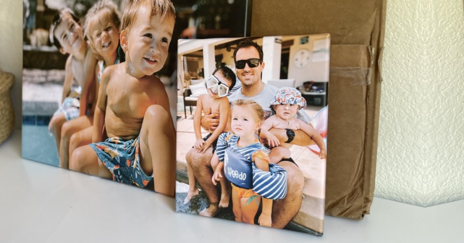 canvas prints of family in swimsuits displayed on countertop
