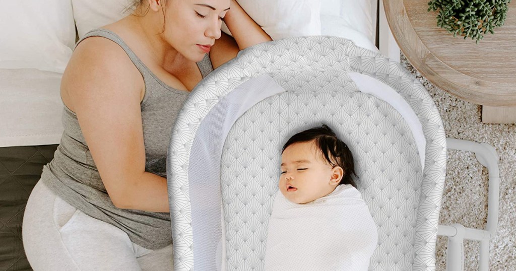 Baby in bassinet next to sleeping mom