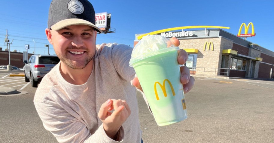 man holding a mconald's shamrock shake