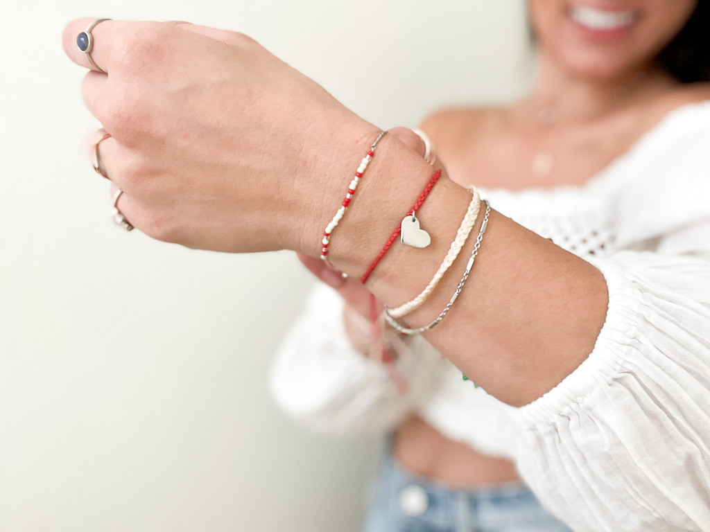 woman showing off wrist with Pura Vida bracelets