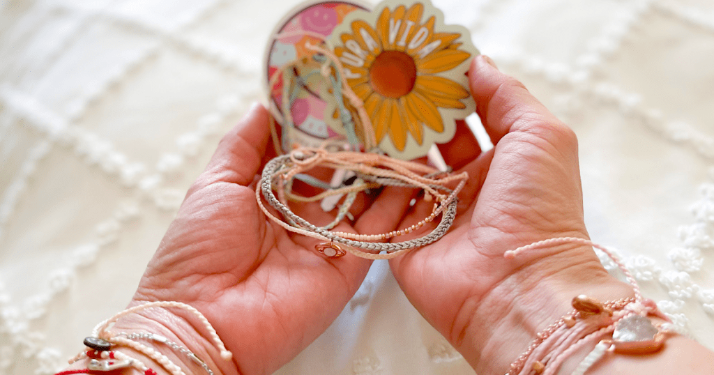 holding Pura Vida bracelets