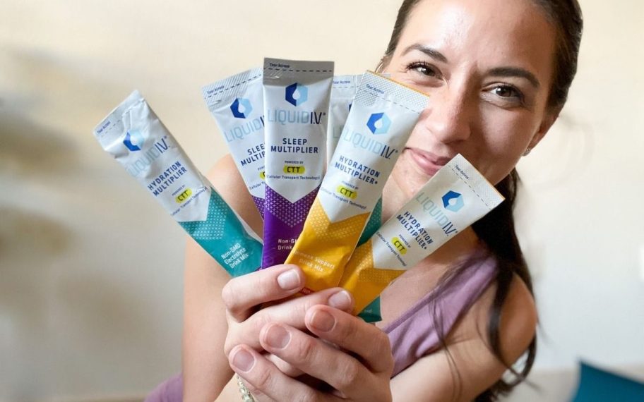 woman holding liquid IV packets