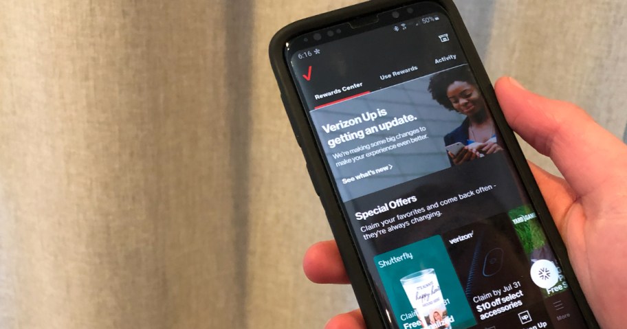 Hand holding phone with Verizon Up
