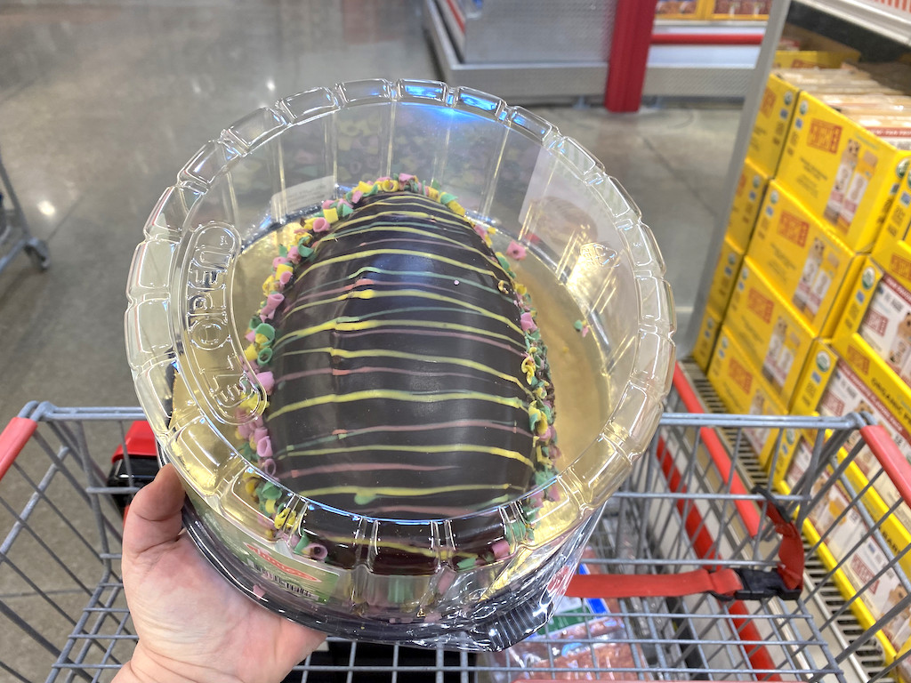 holding large chocolate easter egg cake at Costco
