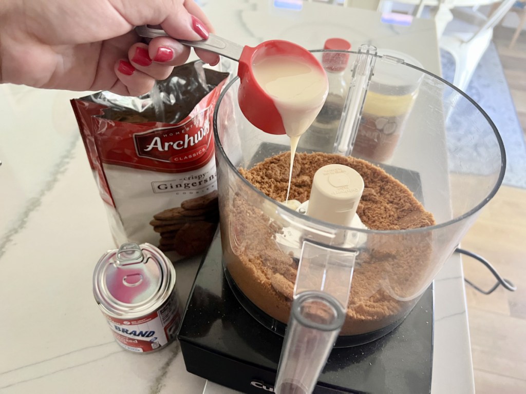 adding sweetened condensed milk to cookie butter