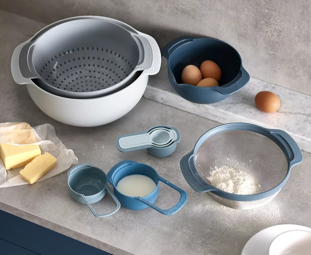 Mixing bowls and measuring cups with ingredients in them on the counter