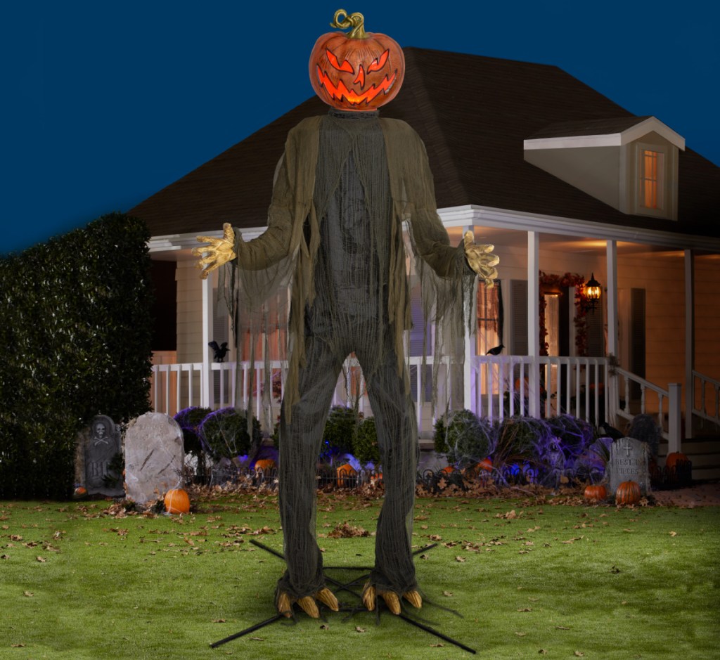 huge pumpkin ghoul decor in yard at night