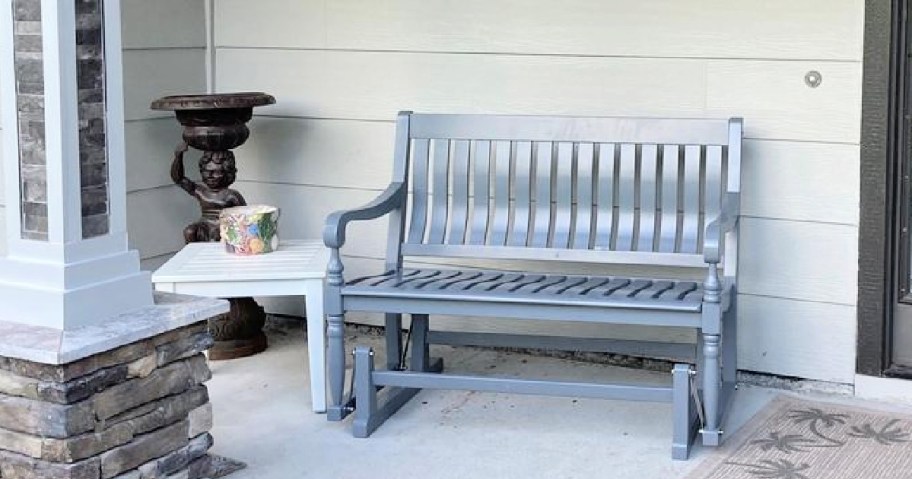 gray glider bench on a porch
