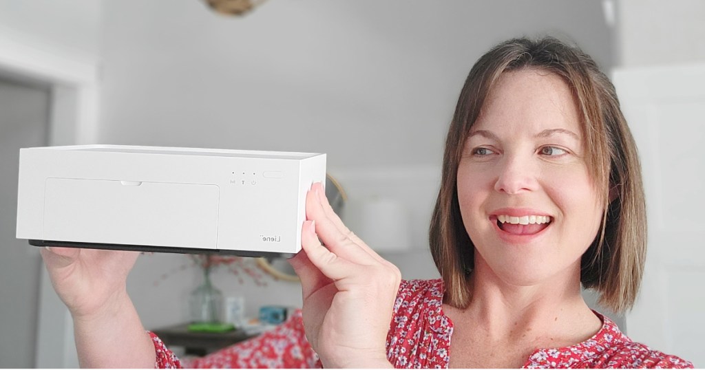 Woman holding instant photo printer