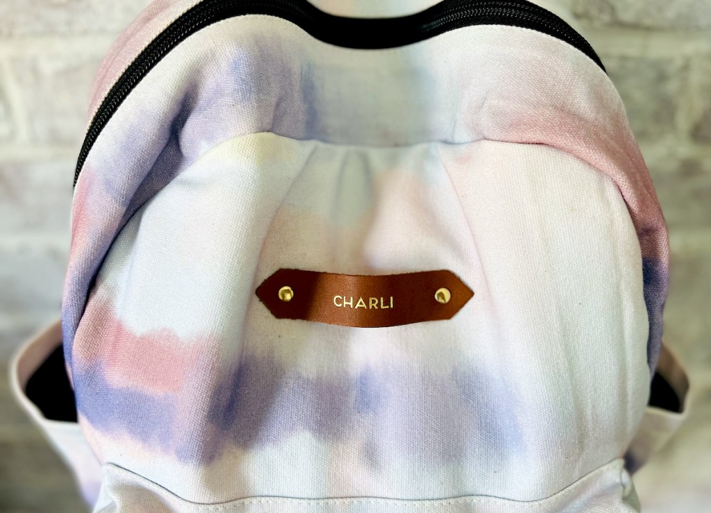 close up of minted tie dye bookbag with name tag