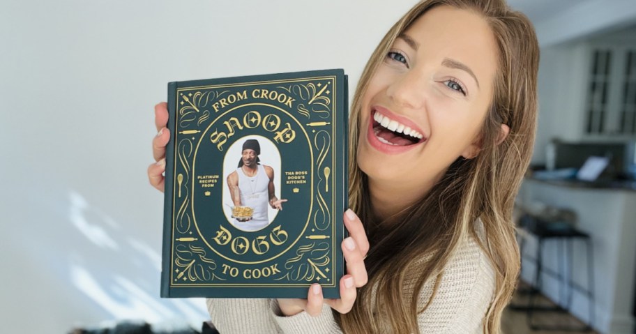 woman holding Snoop Dog Cookbook and smiling
