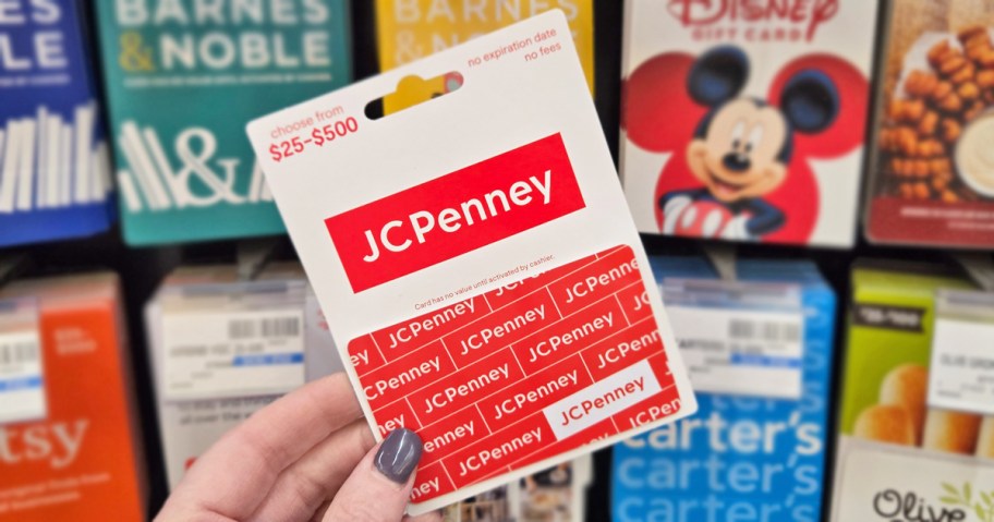 hand holding a red and white JCPenney Gift Card