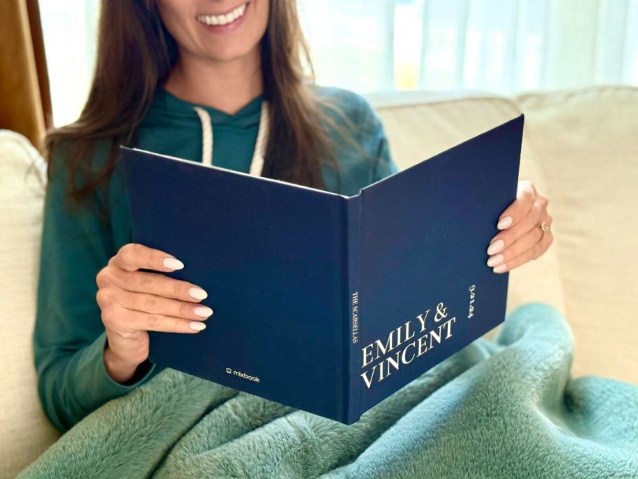 woman holding her mixbook with her name on it 