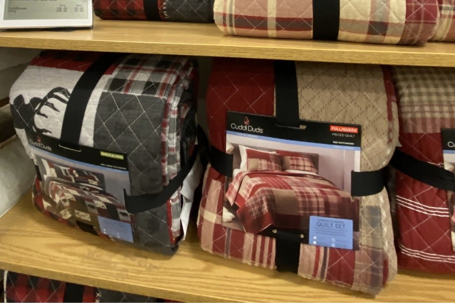 two cuddl duds quilts sets on a store shelf
