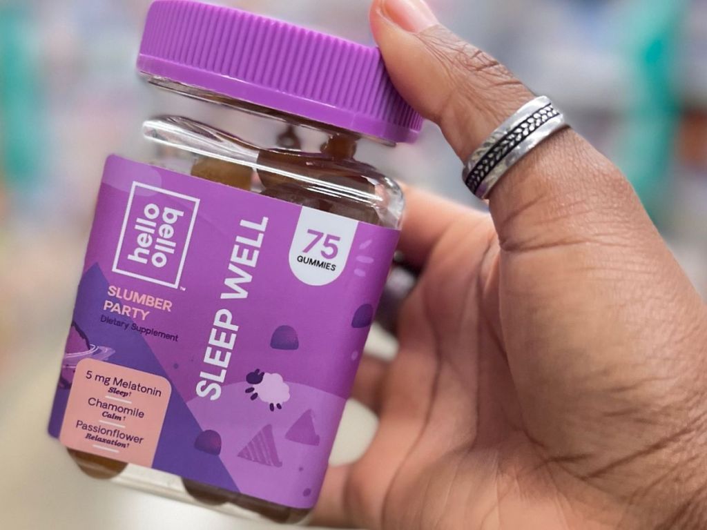 Jar of sleep well Hello Bello vitmamins in person's hand