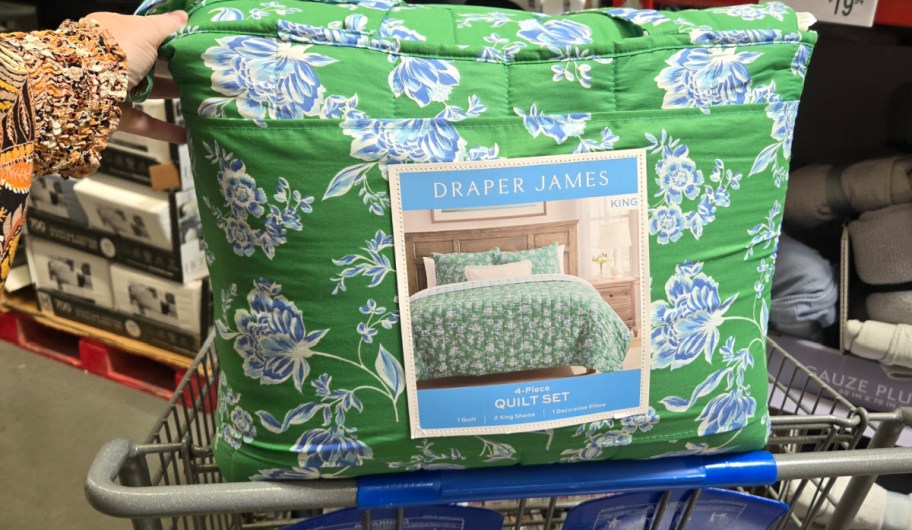 hand holding draper and james green floral bedding on a Sams club shopping cart
