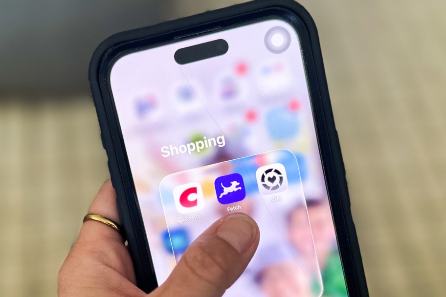 finger tapping on purple app on phone