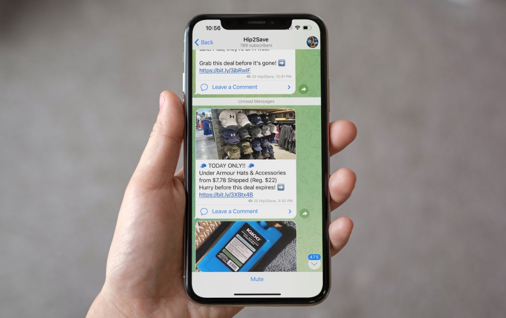 hand holding phone with telegram app on screen