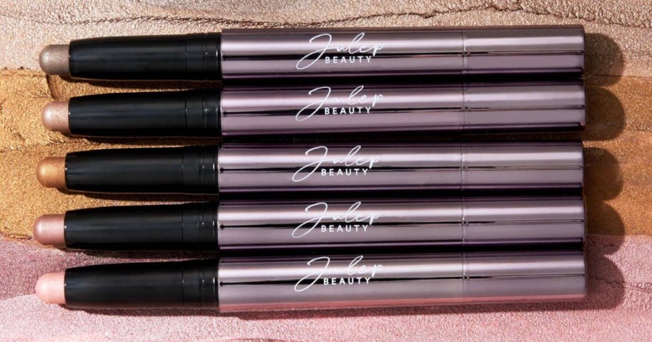 Julep&nbsp;Eyeshadow Sticks with swatches behind them
