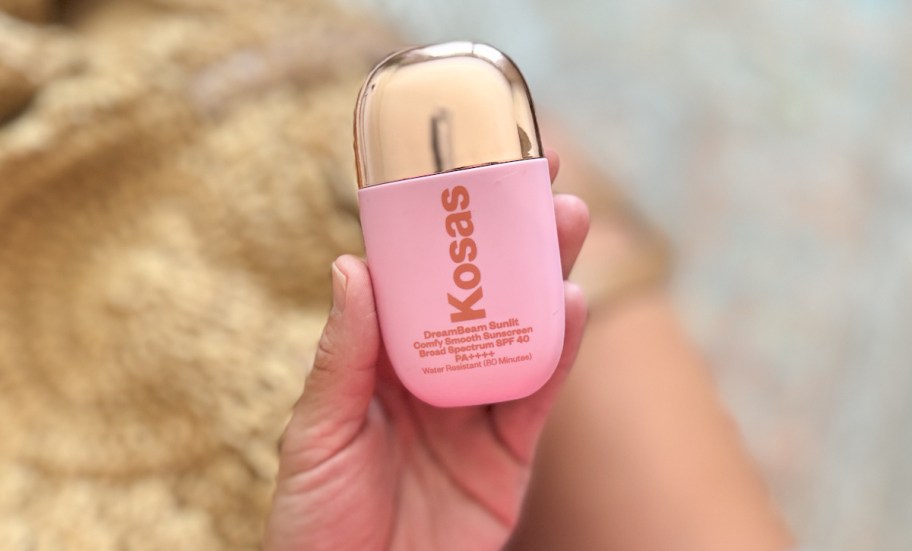 hand holding Kosas DreamBeam SPF 40