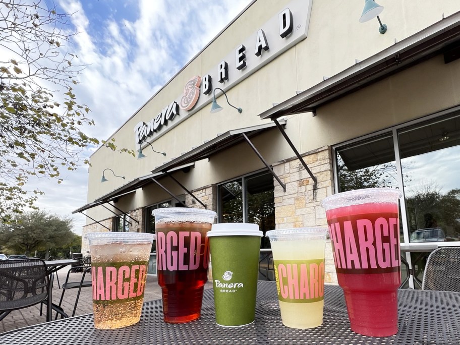 multiple drinks on table outside of panera bread