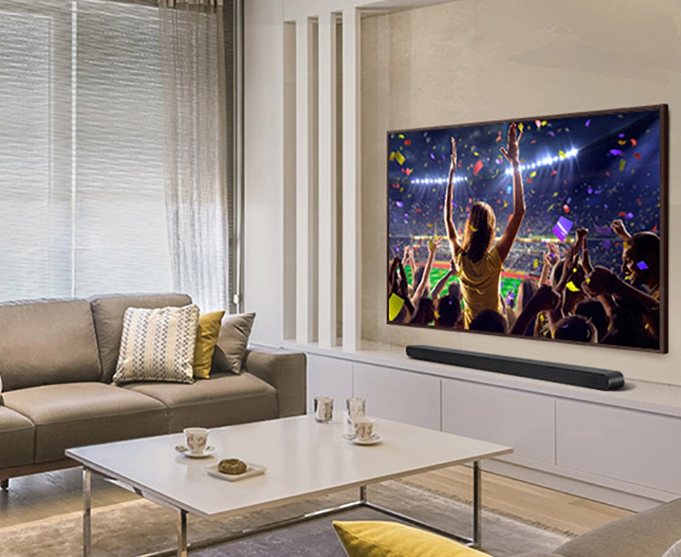 living room with a couch, coffee table, TV, and a soundbar