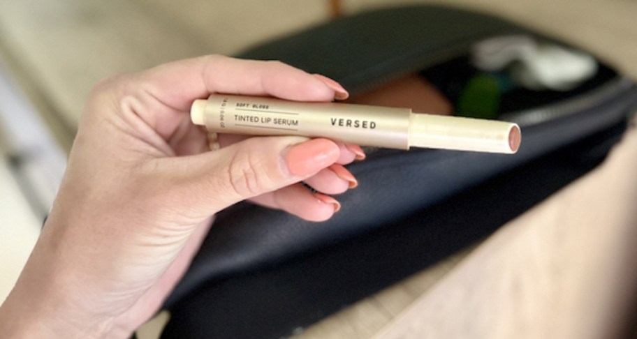 hand holding versed tinted lip serum 