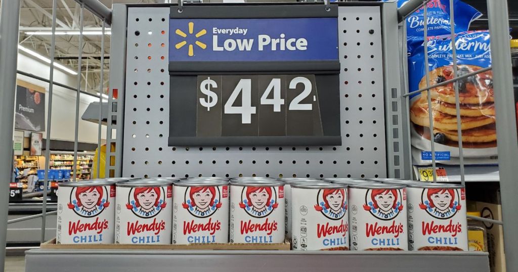 display of canned Wendy's chili at Walmart with price sign above display