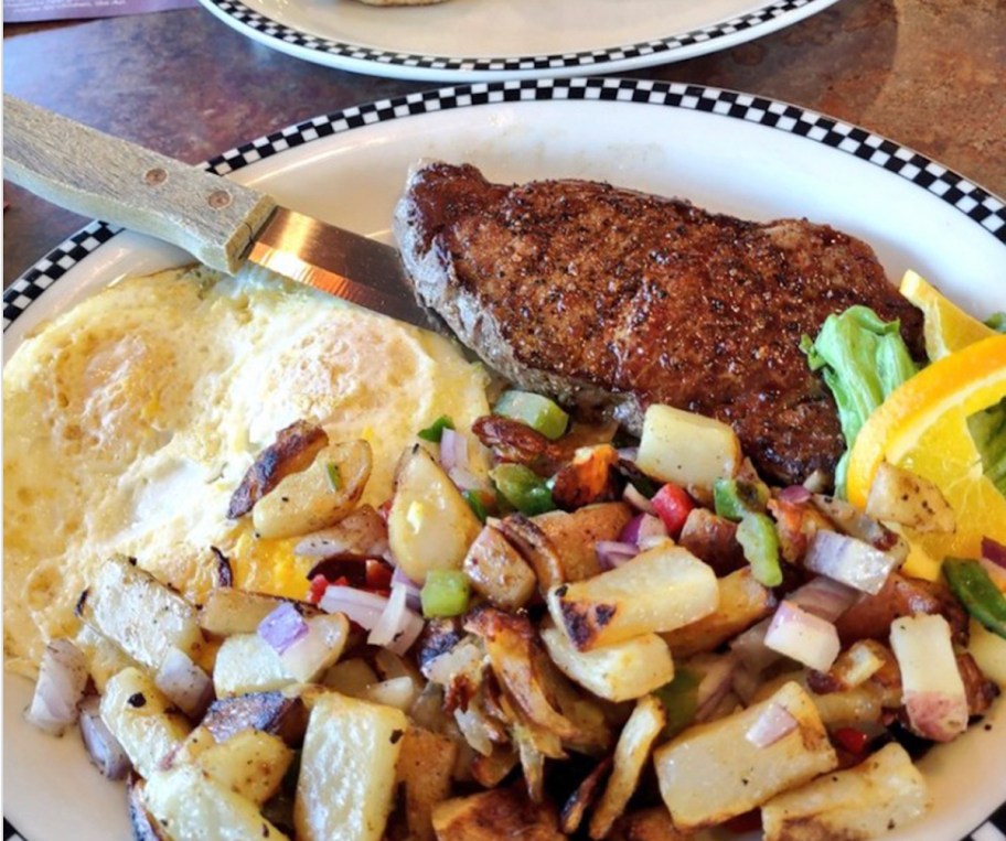steak and eggs meal with potatoes on plate