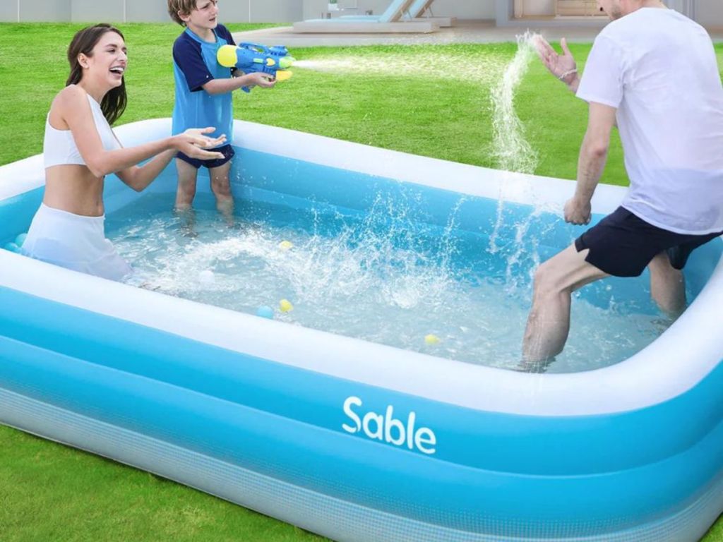 kid and adults playing in inflatable pool