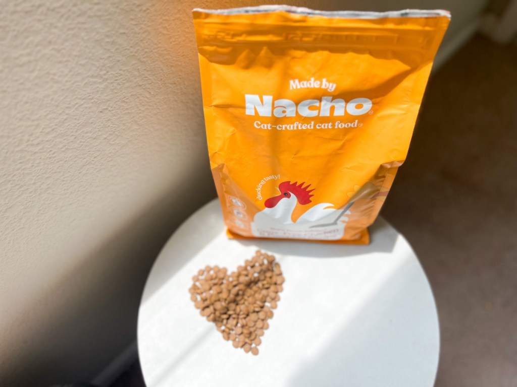 dry cat food in shape of heart next to bag