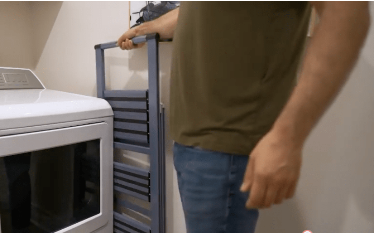 Man storing his EMPOWER foldable lightweight step ladder